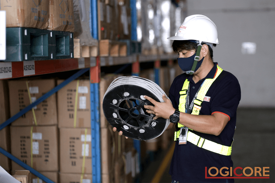 Employee checking all materials at Telco Warehousing - Logicore