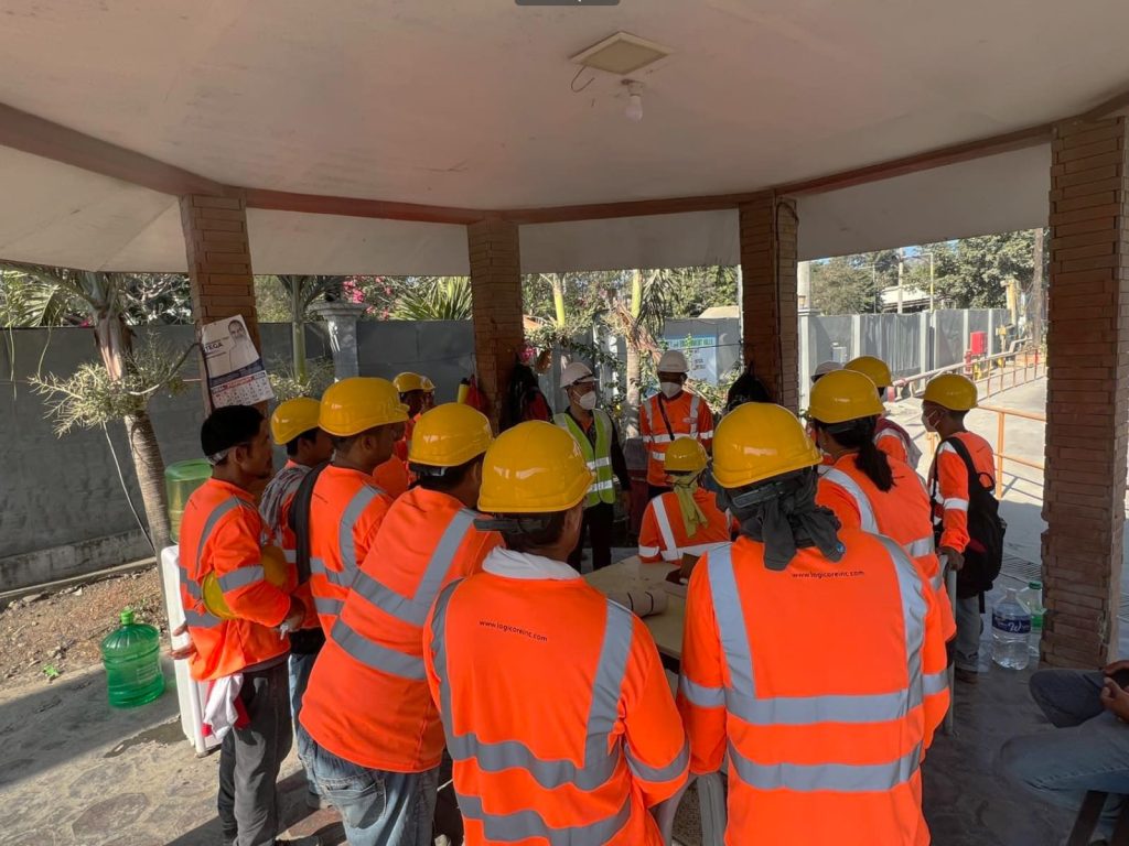 group of construction workers helding a meeting together